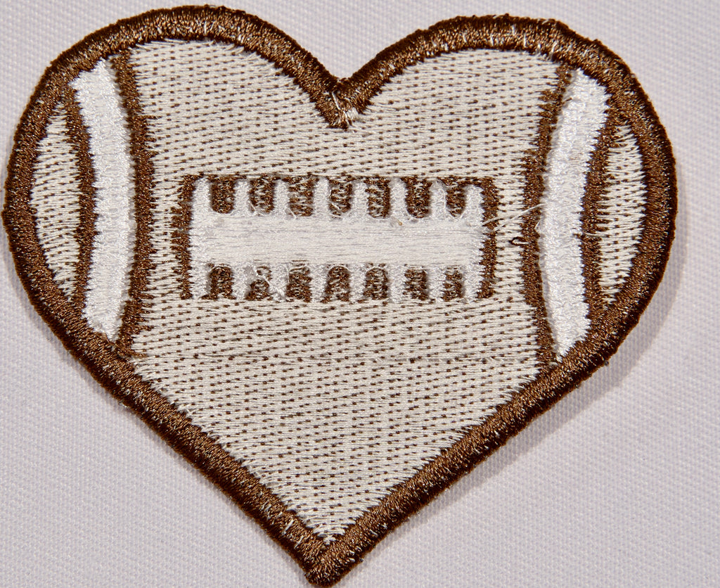 Back: a heart shaped embroidered patch with a football motif.