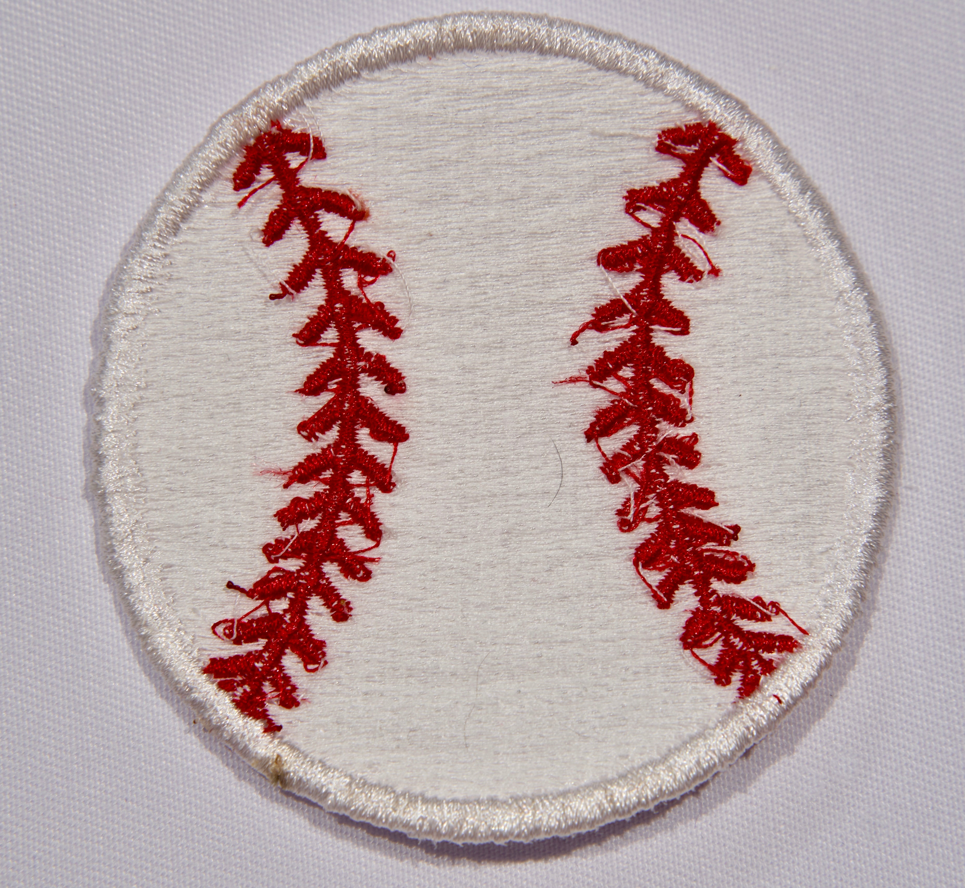 Back: A ln embroidered patch with a baseball motif.