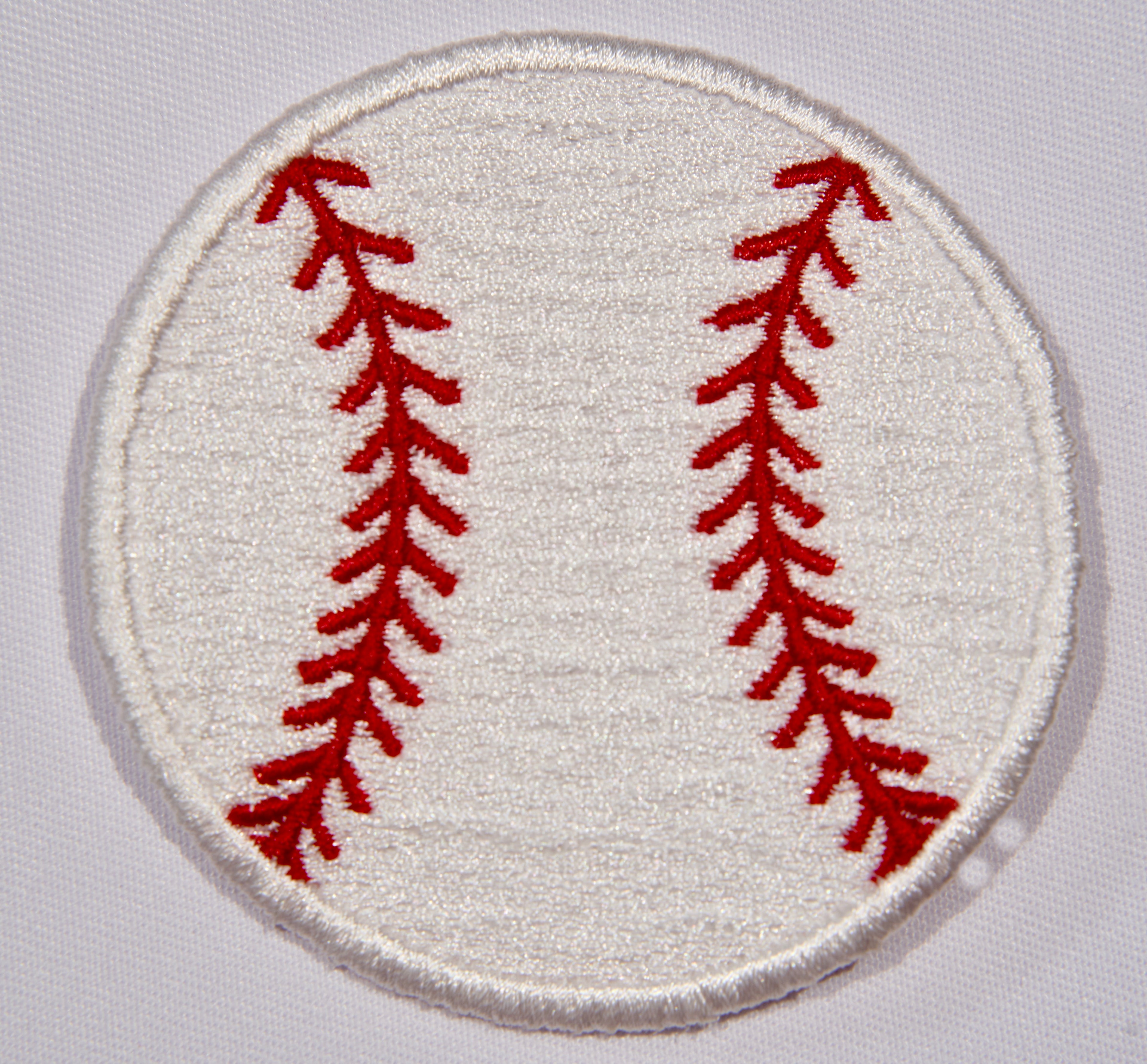 Front: An embroidered patch with a baseball motif. 