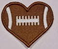 Front: a heart shaped embroidered patch with a football motif