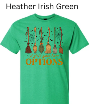 A Girl's Gotta Have Options witch t-shirt heather irish green bright green with six illustrated witch brooms spiders webs bats Halloween fall graphic orange text