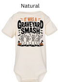 It Was A Graveyard Smash skeleton baby onesie natural cream with four dancing skeletons tombstones pumpkins bats Halloween black orange infant bodysuit