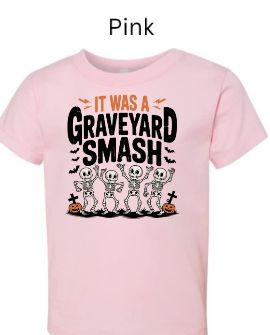 It Was A Graveyard Smash skeleton t-shirt pink with four dancing skeletons Halloween pumpkins tombstones kids graphic tee