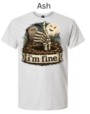 "Ash gray t-shirt featuring Halloween graveyard design: skeletal hand thumbs up from dirt pile, RIP stone marker, smiling moon ghost, 'I'm Fine' banner"