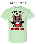 "Mint green t-shirt with cute vampire bat drinking from jar labeled 'The Blood of My Enemies,' 'You Are In My Suck List' text, big eyes, small wings, kawaii Halloween design"