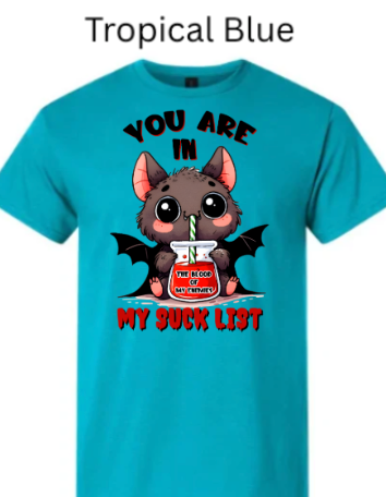 "Tropical blue t-shirt featuring adorable Halloween vampire bat with oversized eyes sipping red liquid through straw, 'You Are In My Suck List' phrase above and below bat graphic"