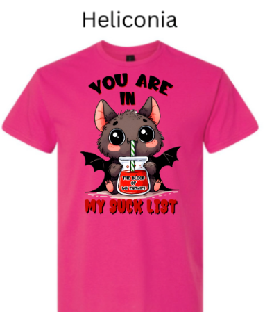 "Bright pink heliconia t-shirt showing adorable vampire bat sipping from 'The Blood of My Enemies' jar, big expressive eyes, 'You Are In My Suck List' text, kawaii style Halloween"