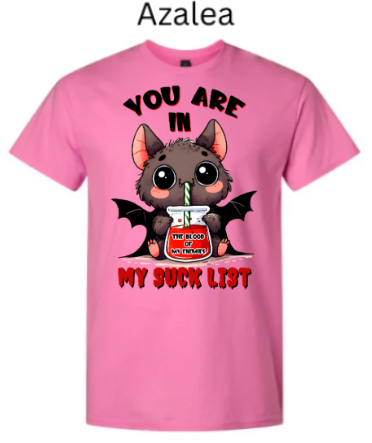 "Pink azalea t-shirt with Halloween vampire bat graphic, oversized eyes and tiny wings, straw in red beverage jar, 'You Are In My Suck List' text above and below, playful spooky design"