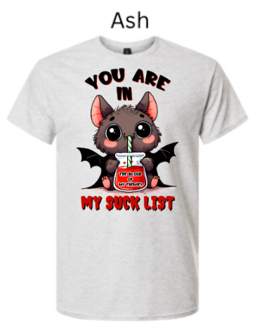 "Ash gray t-shirt displaying cute vampire bat drinking from 'The Blood of My Enemies' jar, black bats wings, 'You Are In My Suck List' red text, kawaii Halloween character graphic"