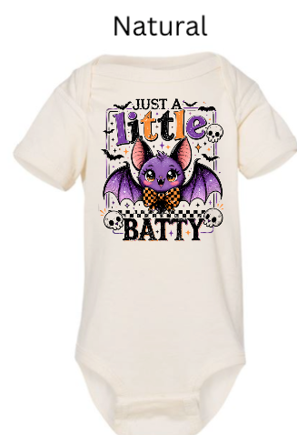 "Natural cream baby onesie with 'Just A Little Batty' purple bat wearing bowtie, skulls and small bats frame, candy corn colored letters, infant Halloween bodysuit"