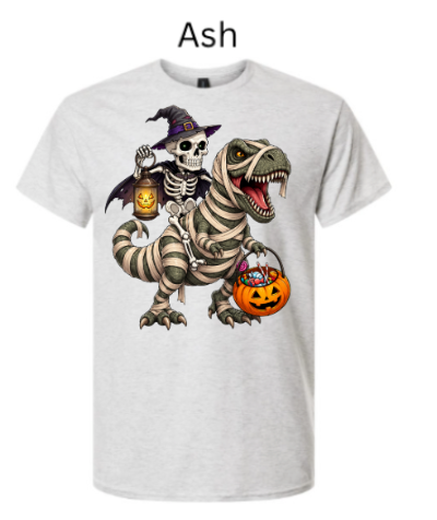 "Ash white t-shirt featuring skeleton witch rider on mummy T-Rex, lantern lights, candy basket, big-eyed wrapped dinosaur, whimsical Halloween trick-or-treat design"