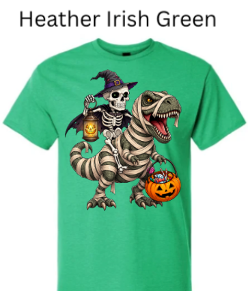 "Irish green heather t-shirt displaying skeleton witch on bandage-wrapped T-Rex, glowing jack-o'-lanterns, pumpkin candy bucket, spooky Halloween dino witch graphic"
