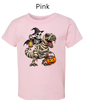 "Pink t-shirt with skeleton witch riding mummy T-Rex holding jack-o'-lantern lanterns and candy basket, Halloween trick-or-treat design, spooky cute dinosaur graphic"