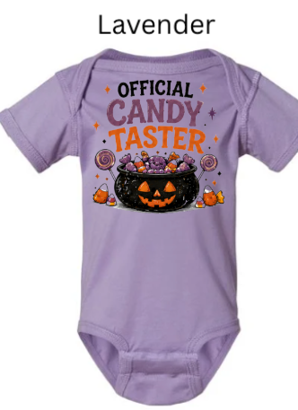 Official Candy Taster infant onesie in lavender purple with pumpkin cauldron full of Halloween candy swirly lollipops and candy corn — adorable first Halloween outfit for baby