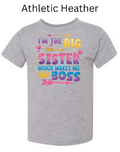Athletic Heather Bella+Canvas 3001T toddler tee with "I'M THE BIG SISTER WHICH MAKES ME BOSS" design. Colorful gradient text with arrows and hearts. Gray heather big sister announcement tee.